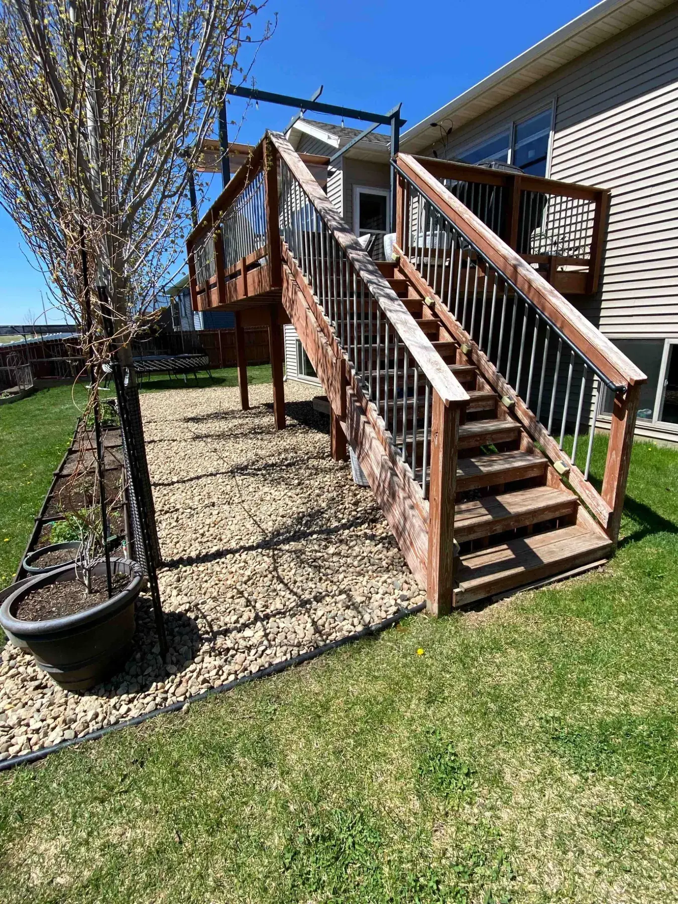 Rock landscaping around a backyard deck completed by Minnlawn
