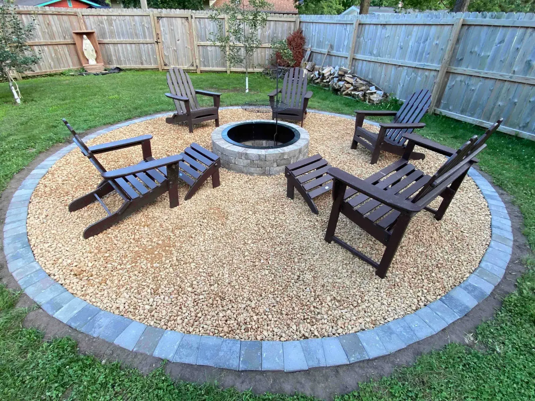 Finished backyard fire pit landscaping project by Minnlawn