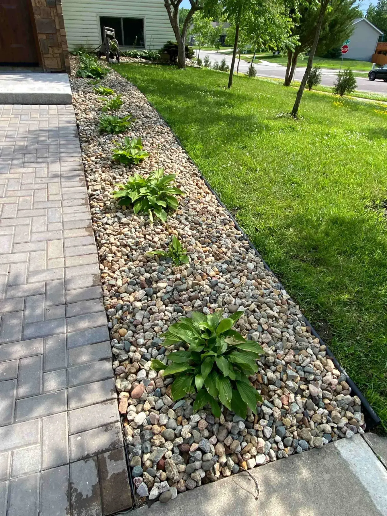 Rock bed and walkway landscaping project completed by Minnlawn